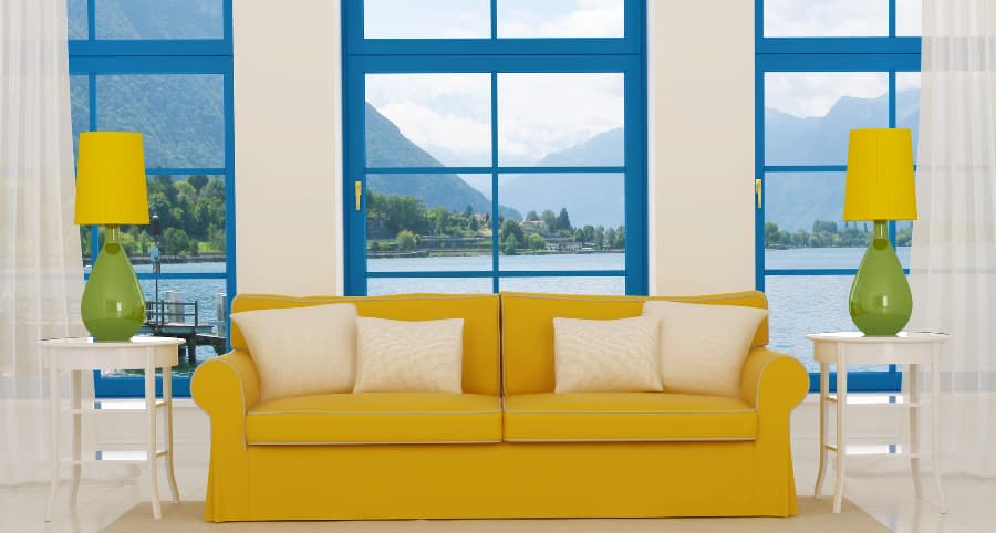 Image of family room windows behind sofa with coordinating lamps and tables